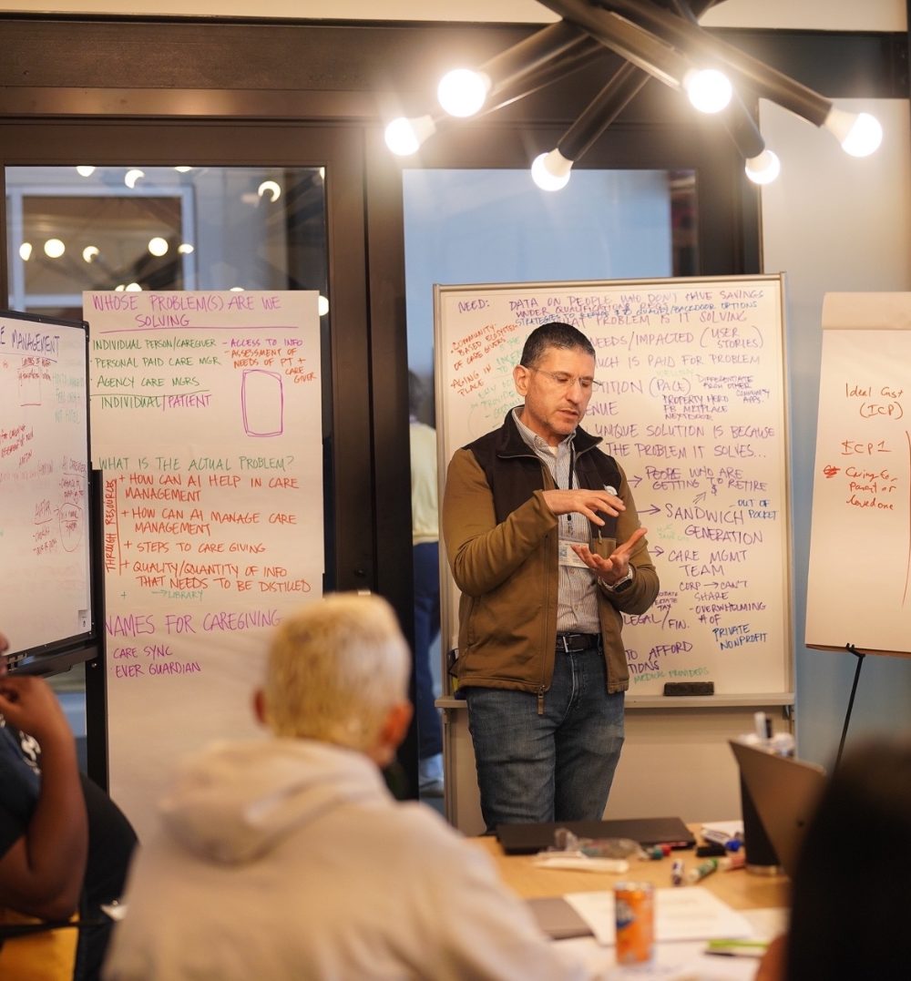 A mentor leads a working session with founders at Vision To Venture